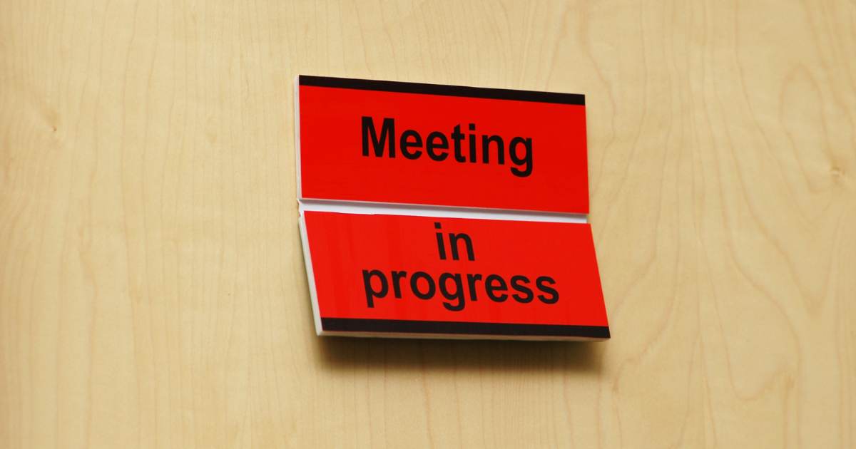 meeting in progress sign